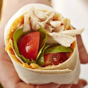 Chicken wrap with sticky sweet potato, salad leaves & tomatoes