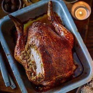 Cumin-spiced roast chicken with pork & pistachio stuffing