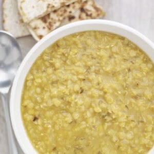 Spicy red lentil soup with cheese chapatis