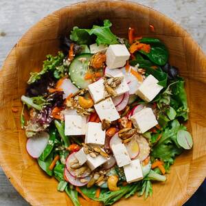 Spinach, Tofu, and Shaved Carrot Salad with Sesame Dressing and Spiced Pepita and Cashew Crunch